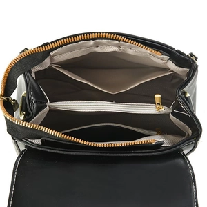 Top view of black leather handbag interior with multiple compartments and gold zipper