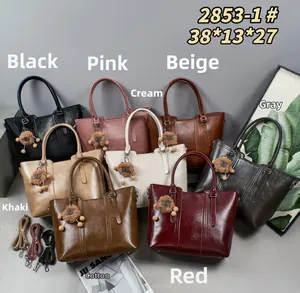Multiple colors of large leather tote bags shown with bear charms and shoulder straps
