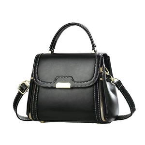 Classic black leather handbag with gold metal hardware and adjustable shoulder strap