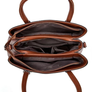 Top view of spacious multi-compartment interior with three zipper pockets in leather handbag