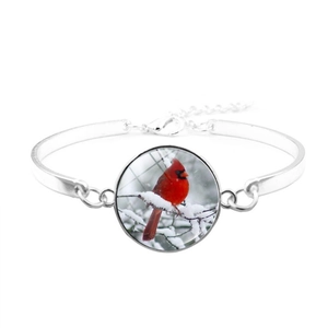 Detailed macro view of silver northern cardinal bird glass cabochon bangle bracelet