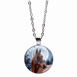 Silver necklace with glass gem pendant featuring a brown horse under a full moon in snow forest