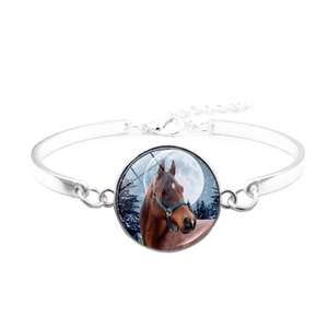 Detailed view of silver horse bangle featuring a glass cabochon with winter forest scene