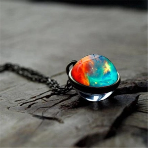 Macro shot of cosmic nebula glass ball pendant with vintage bronze metal base