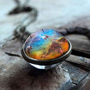 Macro shot of galaxy nebula glass dome pendant with vintage bronze finish on wood