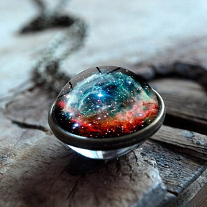 Macro detail of cosmic nebula glass cabochon pendant with vintage bronze bezel