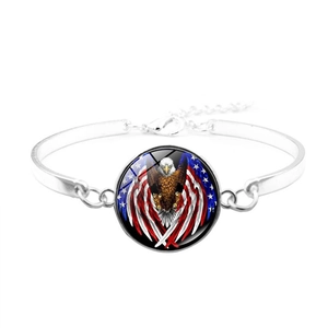 Detailed view of silver bracelet with American flag eagle glass dome and lobster clasp