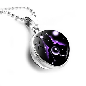Macro view of Gemini constellation pendant with double-sided glass orb and silver chain