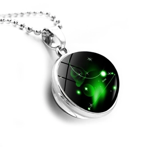Aries zodiac necklace featuring glowing green double-sided glass pendant with silver chain