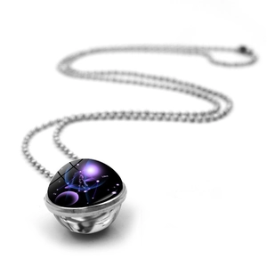 Macro view of double-sided glass Libra constellation pendant with purple galaxy background