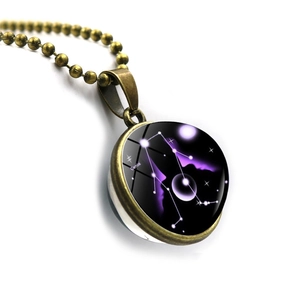 Detail of Gemini constellation necklace with bronze ball chain and double-sided glass dome