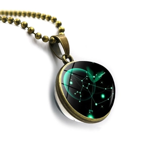 Macro shot of bronze Sagittarius constellation necklace with double-sided glass orb