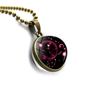 Close-up of Scorpius double-sided glass ball pendant with bronze alloy chain and starry sky