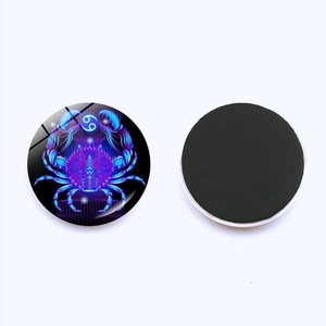 Macro detail showing Cancer zodiac glass fridge magnet with neon blue crab design