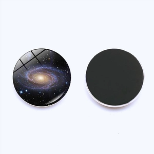 Detail of 30mm galaxy nebula glass fridge magnet with round black soft magnetic backing