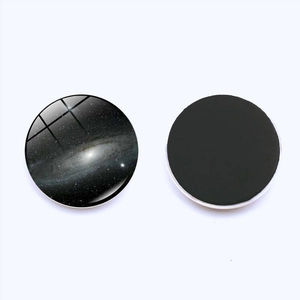 Detail view of the round galaxy glass fridge magnet showing the front and magnetic back