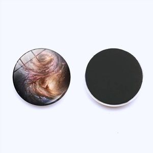 Detailed front and back view of a 25mm cosmic galaxy glass fridge magnet with magnetic base