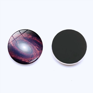 Detailed view of 25mm space galaxy glass fridge magnet with magnetic back and nebula pattern