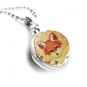Close-up of a double-sided glass ball pendant with a cute orange fox illustration
