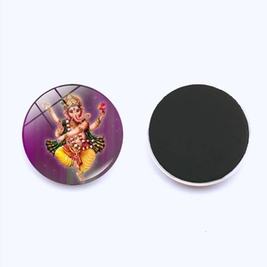 Detail of Ganesha glass fridge magnet showing the colorful front and black magnetic back