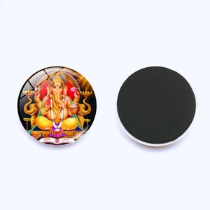 Detail of Ganesha glass fridge magnet showing the colorful deity image and magnetic back