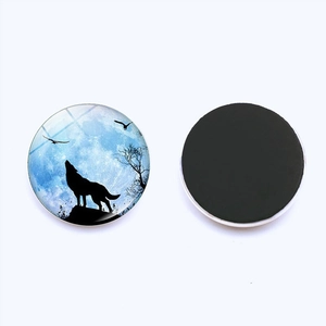 Detail of howling wolf glass fridge magnet showing the artistic blue moonlit front and magnetic back