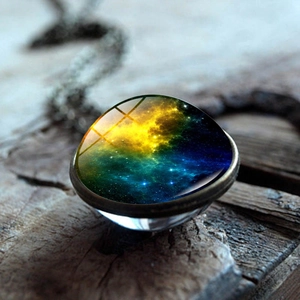 Macro shot of nebula glass sphere pendant with vintage metal base on rustic wood