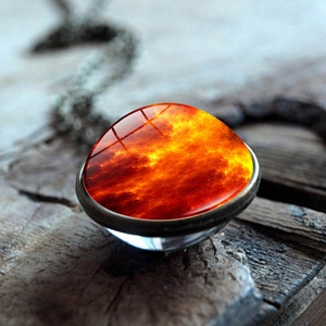 Macro shot of double-sided glass galaxy pendant necklace with orange nebula texture