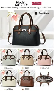 Detail view of multi-compartment interior and metal twist lock of women's crossbody bag