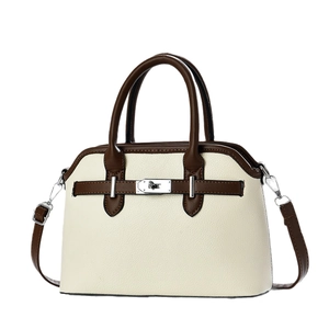 Chic cream and brown contrast crossbody bag with pebble leather and metallic turn-lock