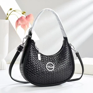 Detail of black woven texture handbag with silver hollow logo and adjustable strap