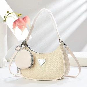 Chic beige woven crescent underarm bag with a round coin purse and metal triangle detail
