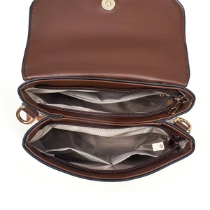 Detail view of brown crossbody bag showing dual zipper compartments and textured lining
