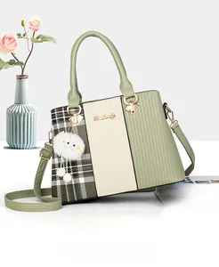 Sage green and beige paneled tote bag with olive checkered side and plush charm accessory