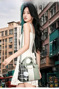 Chic mint green patchwork handbag with plaid pattern and white pompom on urban street