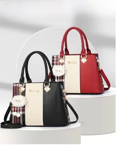 Detail of multi-color stitching and classic plaid pattern on the women's handbag