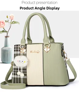 Detail of green patchwork handbag with plush charm and golden brand hardware logo