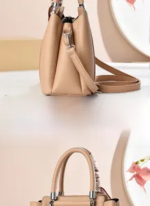 Detail of beige lychee leather handbag with side trapezoid structure and silk scarf handle