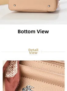Detail view of lychee texture leather bag with metal feet and floral silk scarf decor