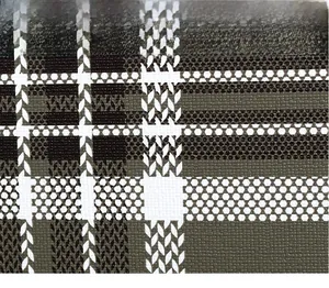 Detailed macro view of black and white checkered texture on synthetic leather handbag