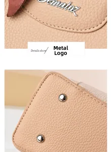 Detail view of lychee grain leather, hardware logo, and protective metal studs on base