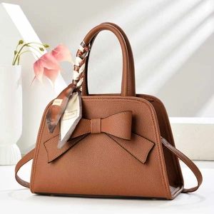 Brown litchi grain handbag with a large bow detail and fashion print silk scarf handle