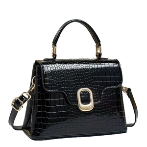 Elegant black crocodile pattern handbag with gold clasp and adjustable shoulder strap