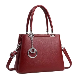 Elegant wine red leather tote bag with top handles and adjustable shoulder strap