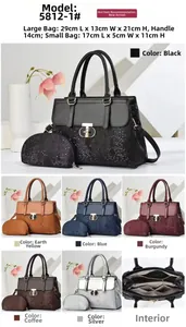 Detail view of snakeskin pattern leather handbag set with round metal lock and dimensions