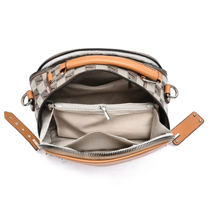 Brown checkerboard shoulder bag with spacious multi-compartment interior and zip pocket