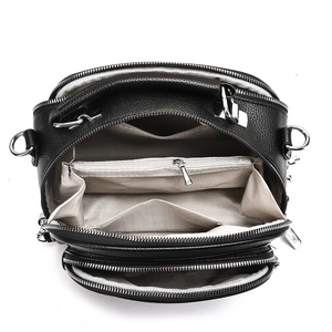Top view of black lychee leather bag with multi-compartment interior and silver zippers