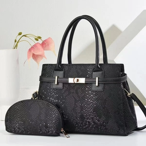 Black snake pattern tote bag set with matching pouch and golden hardware details