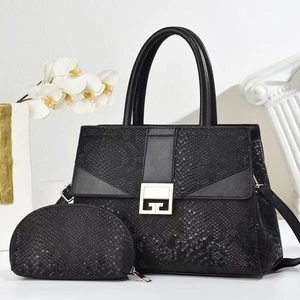 Close-up of black snake pattern handbag with gold clasp and matching coin purse