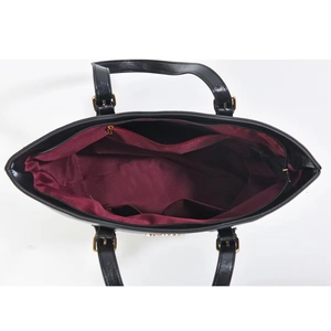 Detailed interior of black leather tote bag with burgundy lining and inner pockets